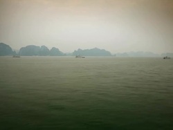 WS T/L POV View of Vessels criss cross expanse of water surrounding by strange towering island shapes fading into distance / Ha Long Bay, Vietnam Stock Footage