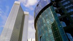 Clouds pass over and reflect in skyscrapers and the Trianon in Frankfurt, Germany. Stock Footage