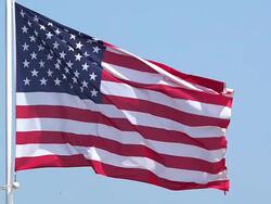 MS SLO MO Shot of American flag waving in wind / Caen, Normandy, France Stock Footage