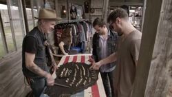 Western shop owner shakes hands with customers looking at ornate rings Stock Footage