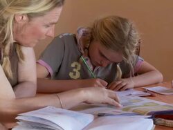 MS Mother helping girl doing school work at home / San Pedro de Atacama, Norte Grande, Chile Stock Footage