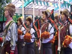 MS  Marching band in Tibetan ceremonial dress sings in formation AUDIO / Dharmasala, Himachal Pradesh, India Stock Footage