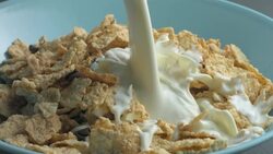 Milk pours on cereal in slow motion. Stock Footage