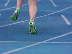 Track and field athlete leaving start line in slow motion Stock Footage