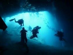 MS  Shot of Silhouette of divers at entrance of Turtle Tomb cave in Sipadan / Sipadan, Semporna, Tawau, Malaysia Stock Footage