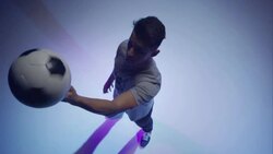 young male soccer freestyler spins a ball on his fingers Stock Footage