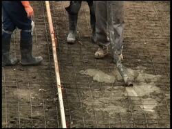 Construction: Squeezing Cement / Concrete Out of Tube Stock Footage
