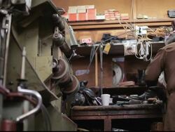 LA Shoe cobbler repairing shoes at workbench / Santa Monica, California, United States Stock Footage