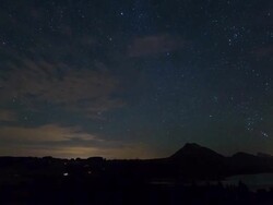 Silhouette of horizon over land and movement of the moon at night Stock Footage