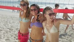 Friends playing beach volleyball Stock Footage