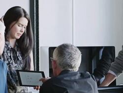 MS businesswoman presenting project on digital tablet to coworkers in high tech startup office Stock Footage
