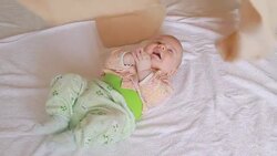 Play and have fun covering baby with cloth Stock Footage