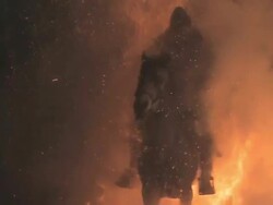 L/S Horses and riders crossing big flames Stock Footage