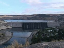 Wide Shot zoom-in - A huge dam creates a reservoir / Grand Coulee Dam, Washington Stock Footage