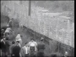 B/W 1961 people helping others escape thru barbed wire fence of Berlin Wall / Germany / newsreel Stock Footage