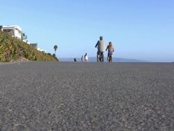 Cyclists and Rollerblading on Beach Path Stock Footage