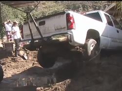 Crews waded through thigh-high mud to check for gas leaks and survey damage in the foothills north of Los Angeles Sunday as evacuated residents waited to find out if they could return to their homes and start digging out. News Clip