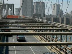 TS Traffic lane on Brooklyn Bridge with pedestrians in bike lane facing Manhattan / New York, New York, USA   Stock Footage