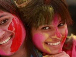 Portrait of a two young women celebrating holi festival Stock Footage