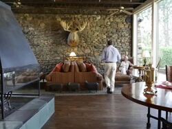 hotel lobby fireplace fire man woman husband wife couple coffee hot chocolate holiday vacation resort getaway lodge  Stock Footage