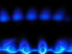 Timelapse close up tilt down of flames on a gas ring on a natural gas cooker Stock Footage