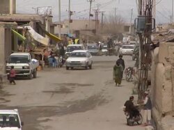 WS Traffic on road in village / Musa Qala, Helmand Province, Afghanistan. Stock Footage