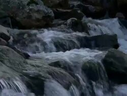 Close up water flowing over rocks and boulders in mountain stream, Brecon Beacons, Wales Stock Footage