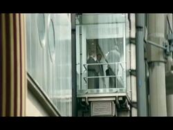 MS Tilt up, People going up in glass elevator on outside of building, Leadenhall Market, London, England Stock Footage