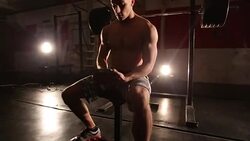 Muscular man uses tablet in the gym Stock Footage