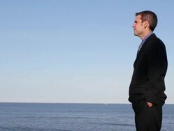 MS Man looking out over ocean / Portland, ME, United States Stock Footage