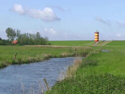 WS View of Pilsum lighthouse near Krummhorn at North Sea (Eastern Friesland) / Lower Saxony Stock Footage