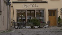 A cobblestone alley leads to a quaint cafe in Frankfurt, Germany. Stock Footage