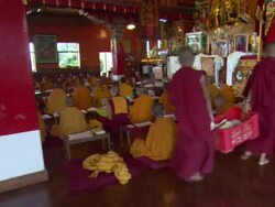 WS PAN Two Buddhist monk children carrying carton of flat bread in monastery Kopan hill / Kathmandu, Central, Nepal Stock Footage