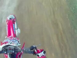 POV helmet cam view of motocross motorcycle riding and doing a jumping trick. - Slow Motion - 1920x1080 Stock Footage