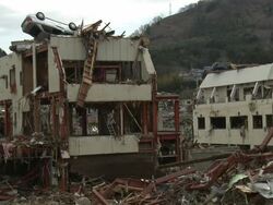 Destruction in Onagawa city, near Sendai Japan on 3rd April 2011; after tsunami following Tohuku earthquake of March 2011.  Car on roof of ruined building Stock Footage