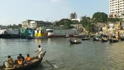 Sadarghat Launch Terminal in Dhaka Bangladesh is a bustling passenger transport hub where tiny wooden boat taxis paddle alongside huge steel ferries Stock Footage