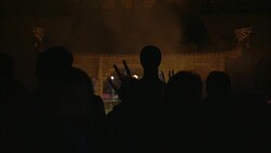 Monks and celebrants gather around an altar where incense smokes. Stock Footage
