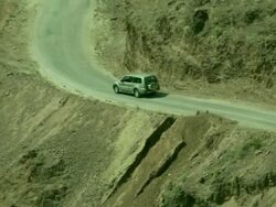 Vehicle descends mountain road in Jordanian Mountains Stock Footage
