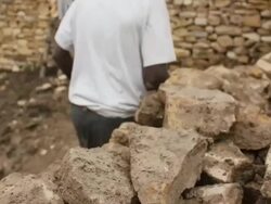 Afar men build stone enclosure Stock Footage