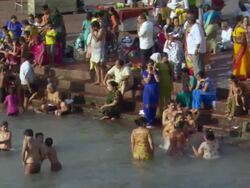 WS PAN TD People splashing in Ganges and sitting on its banks / Haridwar, Uttarakhand, India Stock Footage