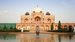 Tourists walk in the garden surrounding the mausoleum holding Humayun's tomb in Delhi, India. Stock Footage