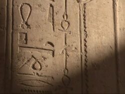Medium Close Up, tilt-up - Ancient Egyptian hieroglyphics cover a stone wall Stock Footage