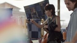Young woman hands credit card to cashier at checkout counter in Texas flea market Stock Footage