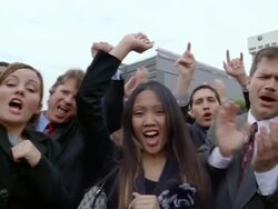Slow motion medium shot pan crowd of smiling businesspeople cheering and clapping Stock Footage
