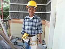 MS Boy (8-9) wearing hard hat, holding hammer / Los Angeles, California, USA Stock Footage