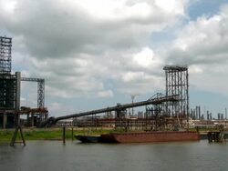 Oil refinery tower from river point-of-view Stock Footage