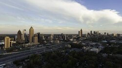 Elevated view over Interstate 85 passing the Midtown and Downtown Atlanta skyline, Georgia, United States of America Stock Footage