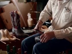 MS PAN R/F boot maker using tool to stretch leather and place tacks in sole of cowboy boot Stock Footage