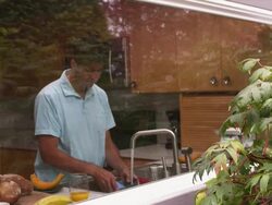 MS Shot from outside window of man washing dishes and looking outside / Portland, Oregon, United States Stock Footage