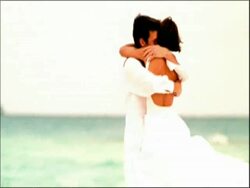 MS couple running and cuddling on beach Stock Footage